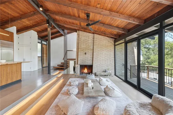 a living room with furniture a fireplace and wooden floor