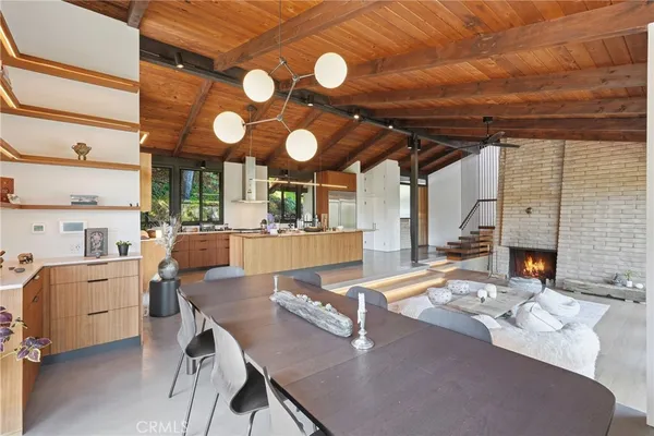 a view of a dining room with furniture and chandelier