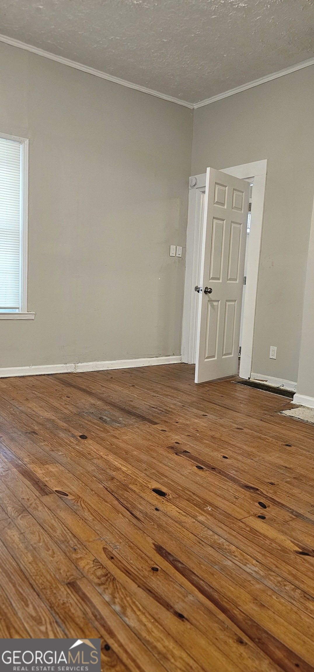 508 Wheeler Street Griffin, GA 30223 - Photo 11 of 23 an empty room with wooden floor and windows