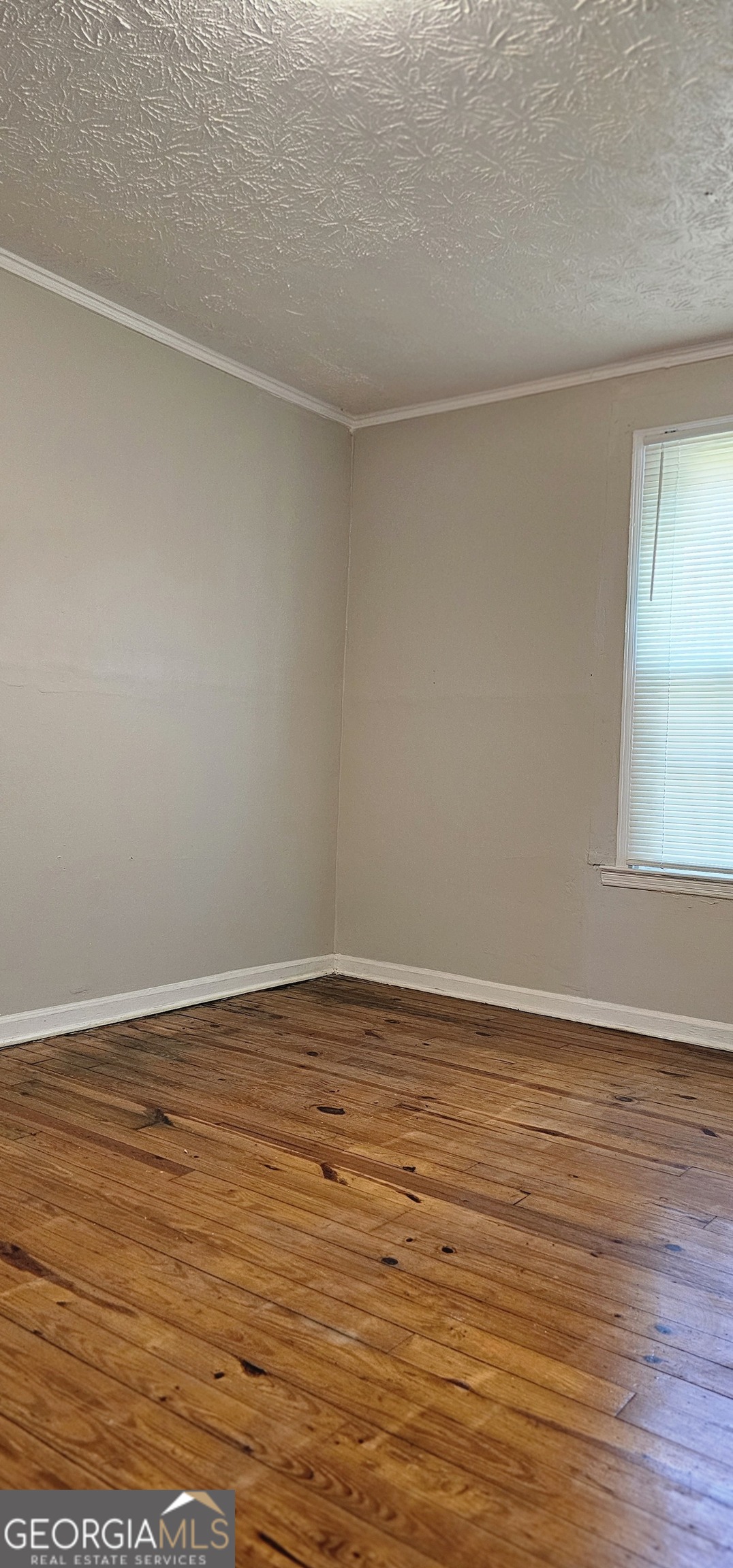 508 Wheeler Street Griffin, GA 30223 - Photo 12 of 23 a view of an empty room with wooden floor and a window