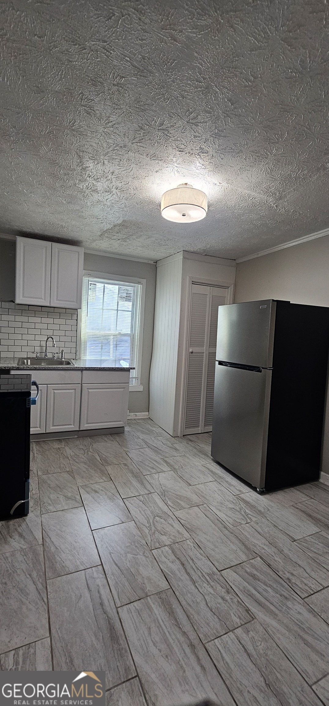 508 Wheeler Street Griffin, GA 30223 - Photo 17 of 23 a view of kitchen with granite countertop cabinets and refrigerator