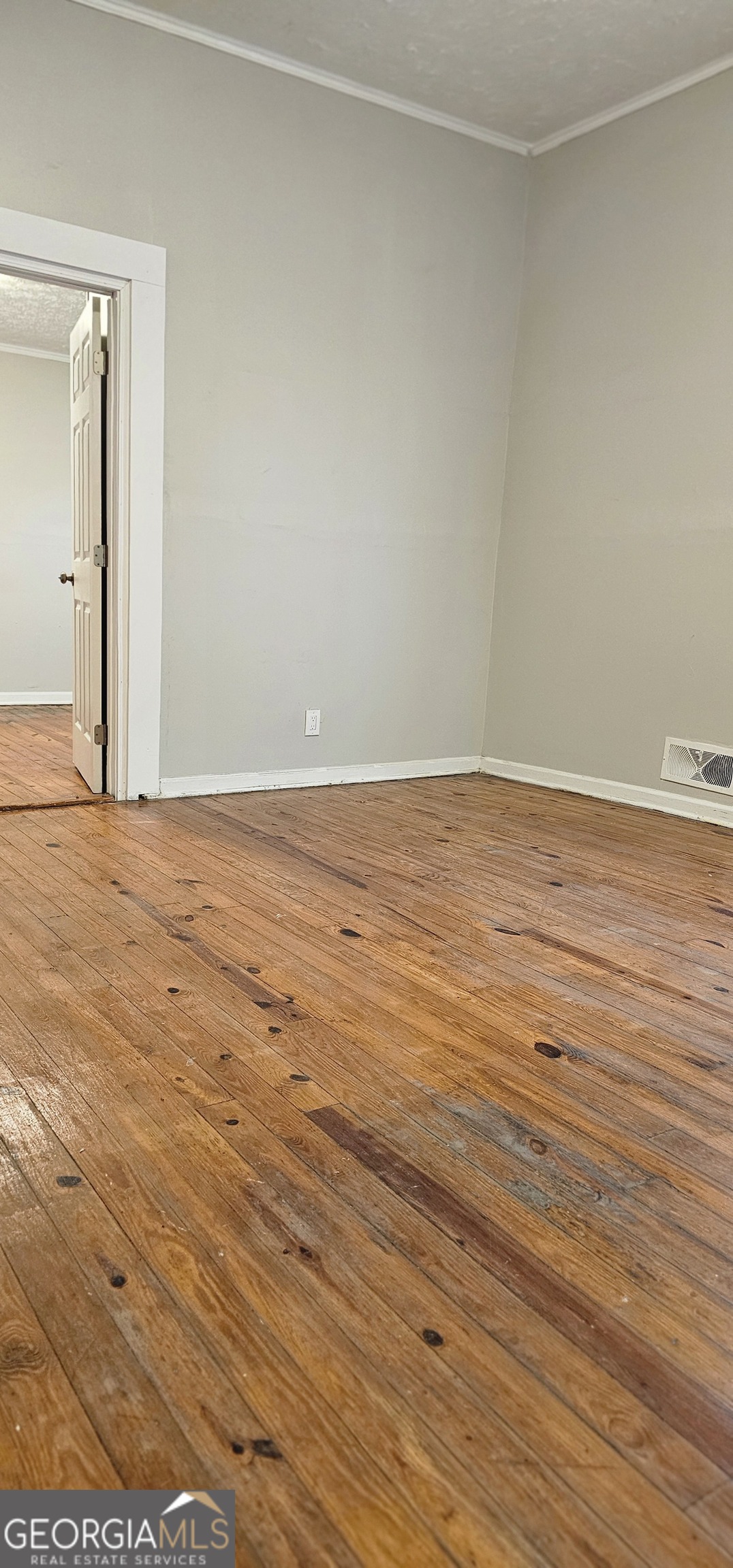 508 Wheeler Street Griffin, GA 30223 - Photo 19 of 23 an empty room with wooden floor and windows