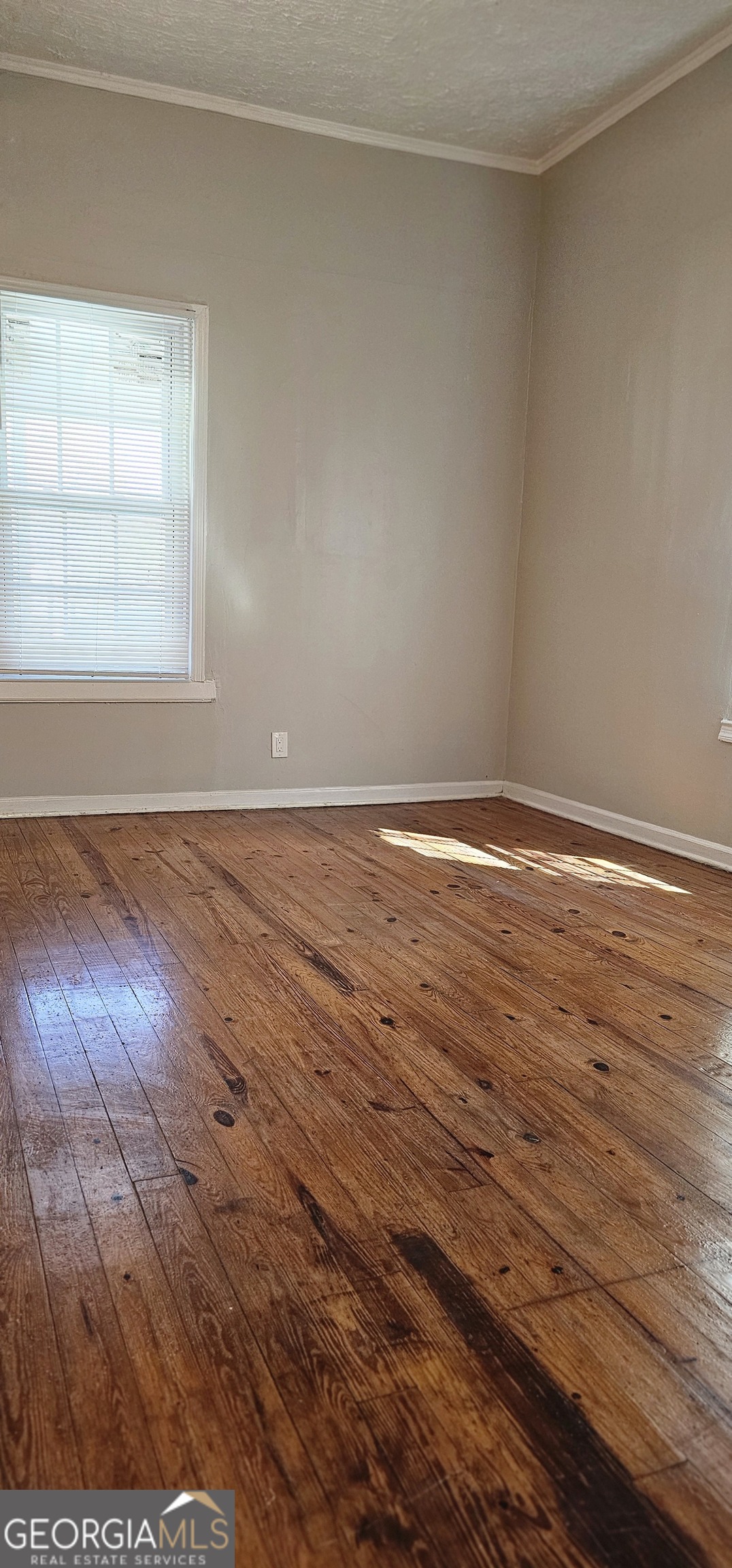 508 Wheeler Street Griffin, GA 30223 - Photo 9 of 23 an empty room with wooden floor and windows