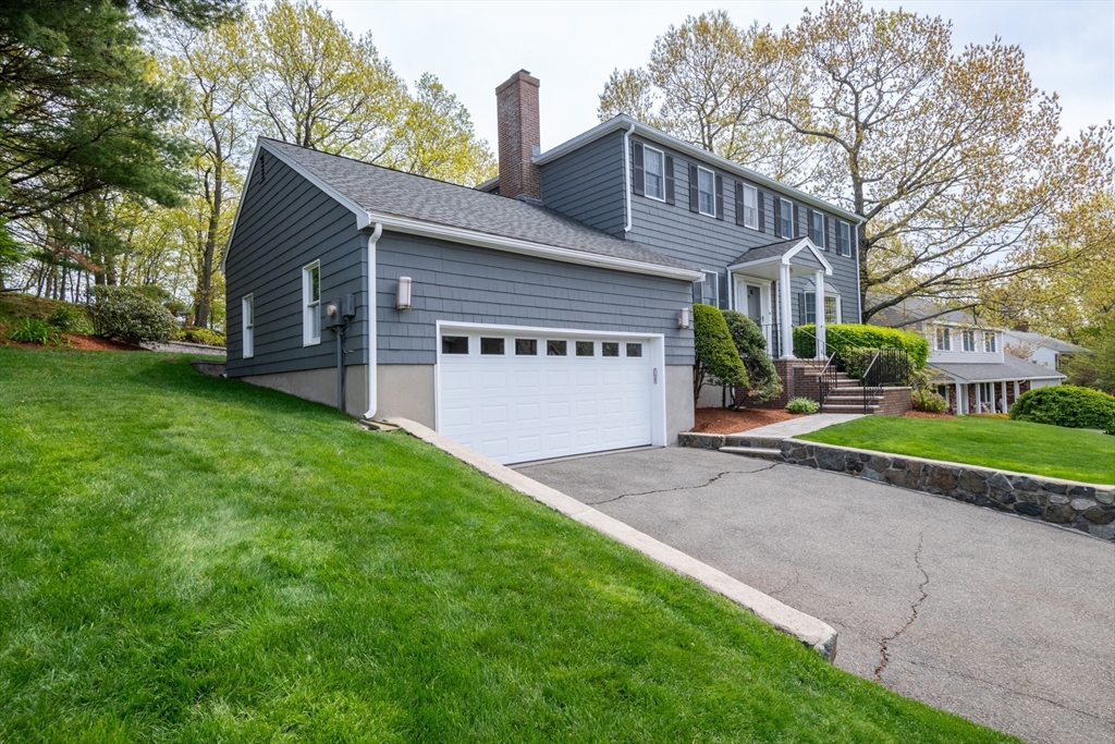 25 Ellen Road Stoneham, MA 02180 - Photo 2 of 41 a front view of a house with a yard and garage