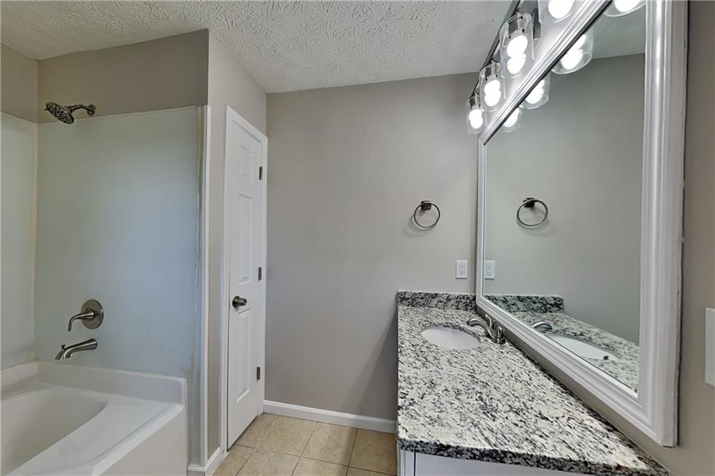 42 Breckenridge Drive Powder Springs, GA 30127 - Photo 11 of 24 a bathroom with a granite countertop sink and a mirror