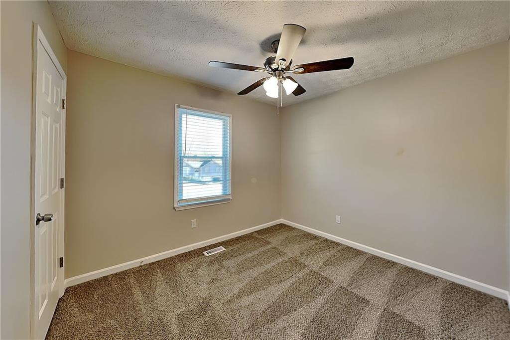 42 Breckenridge Drive Powder Springs, GA 30127 - Photo 13 of 24 an empty room with windows and fan