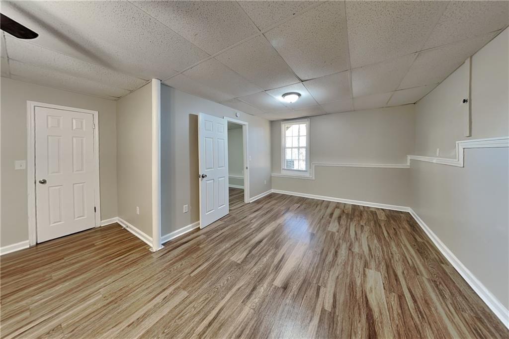 42 Breckenridge Drive Powder Springs, GA 30127 - Photo 18 of 24 an empty room with wooden floor and windows
