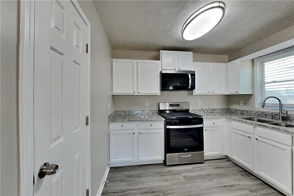 42 Breckenridge Drive Powder Springs, GA 30127 - Photo 3 of 24 a kitchen with stainless steel appliances granite countertop a stove and a sink