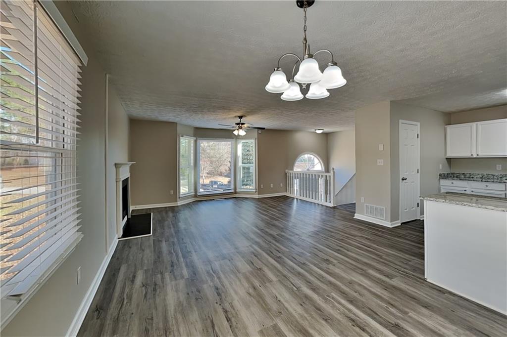 42 Breckenridge Drive Powder Springs, GA 30127 - Photo 5 of 24 a view of an empty room with a window and wooden floor