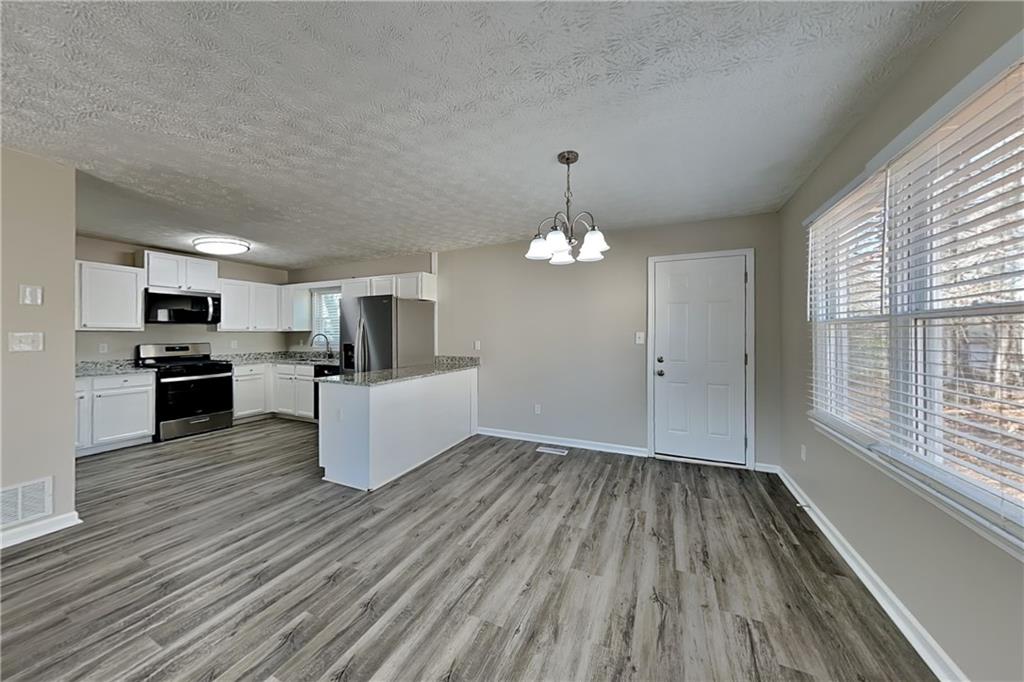 42 Breckenridge Drive Powder Springs, GA 30127 - Photo 6 of 24 a view of kitchen living room with wooden floor and kitchen