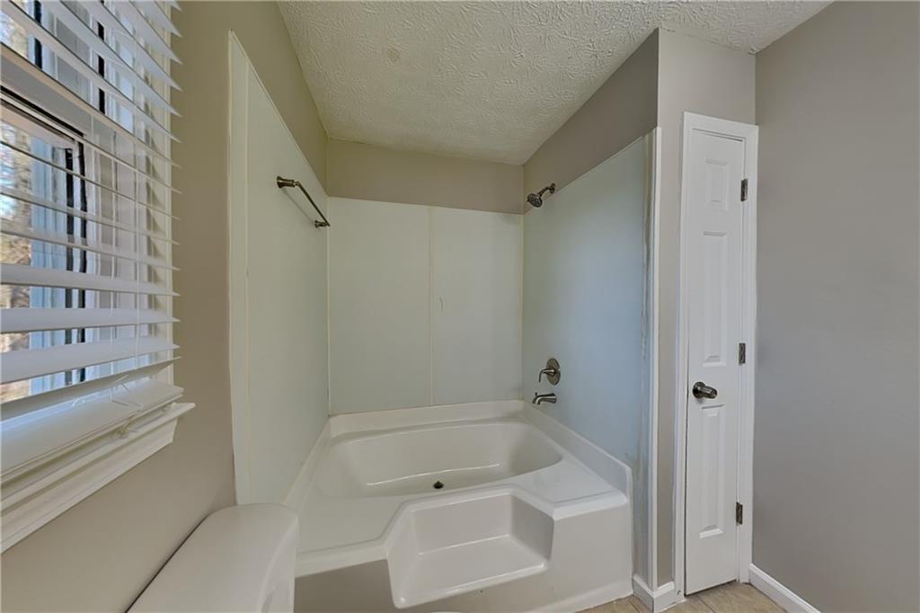 42 Breckenridge Drive Powder Springs, GA 30127 - Photo 10 of 24 a bathroom with a tub shower and vanity