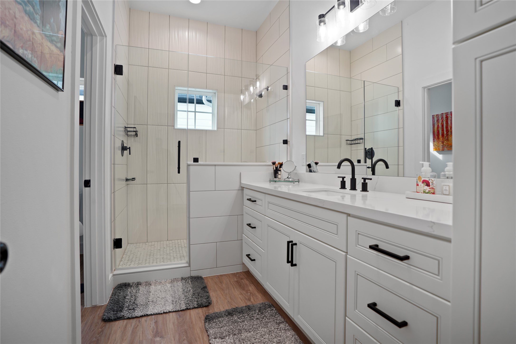 303 Blueberry Street, Unit B Houston, TX 77018 - Photo 27 of 39 a bathroom with double vanity sink a mirror a glass door a shower and vanity