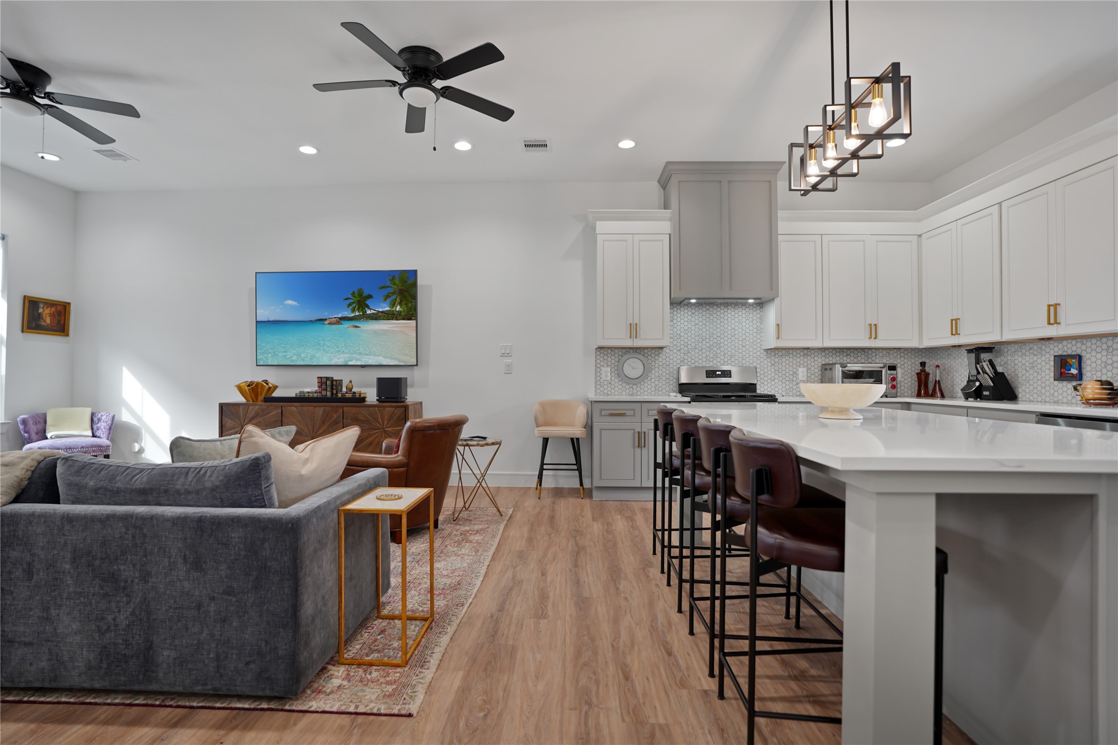 303 Blueberry Street, Unit B Houston, TX 77018 - Photo 10 of 39 a living room with stainless steel appliances kitchen island granite countertop a stove a sink a dining table and chairs with wooden floor
