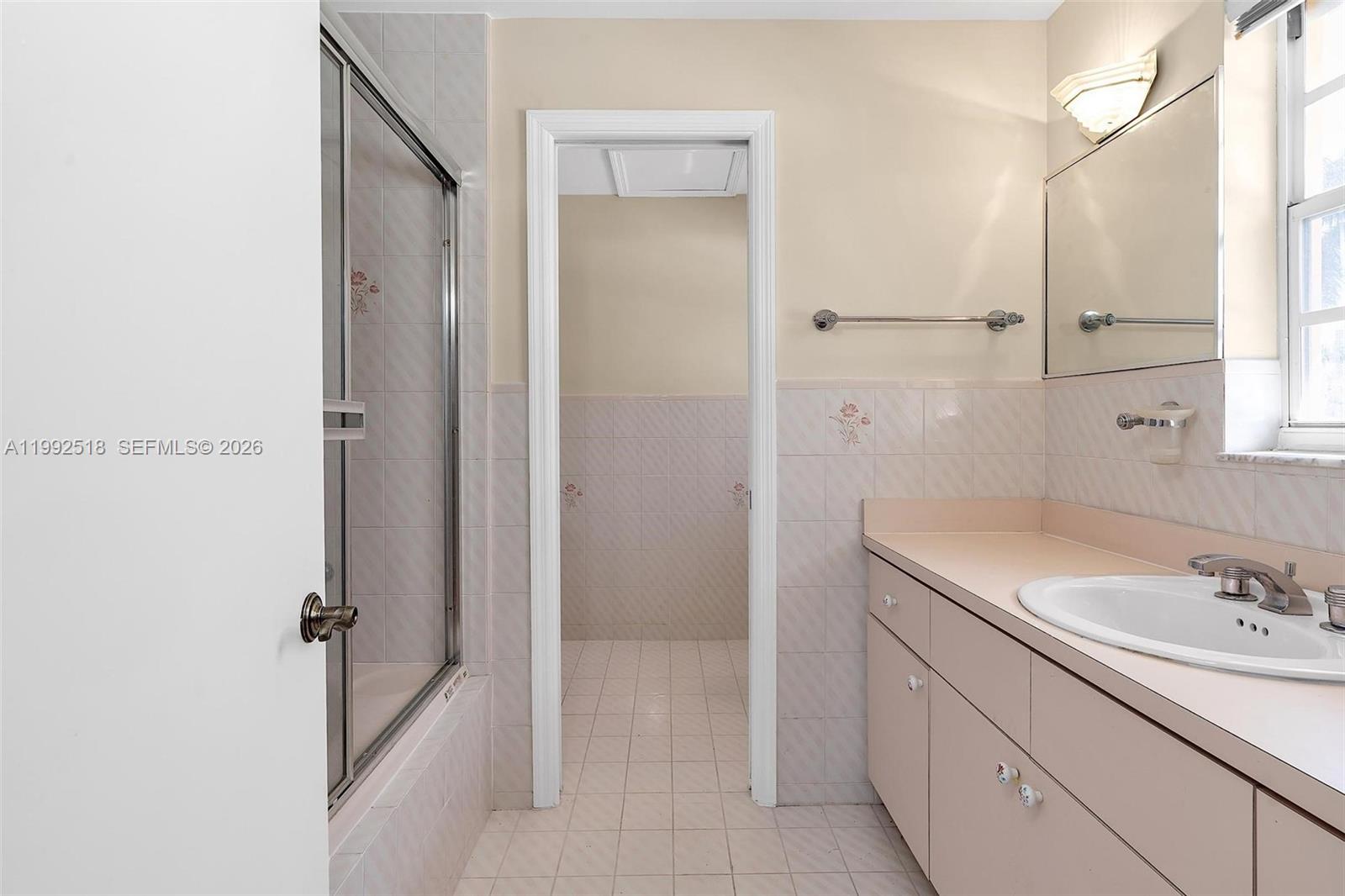 5309 Alton Road Miami Beach, FL 33140 - Photo 25 of 51 a bathroom with a sink and a mirror