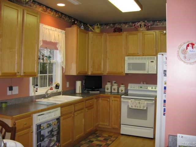 101 Rocca Circle Raleigh, NC 27603 - Photo 4 of 7 a kitchen with a sink stove and cabinets