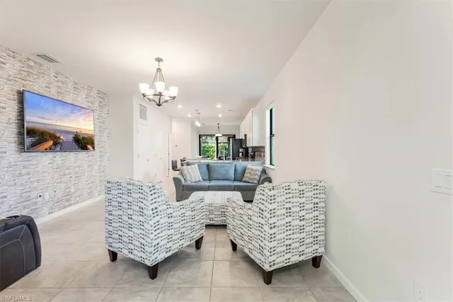 a living room with furniture and a chandelier