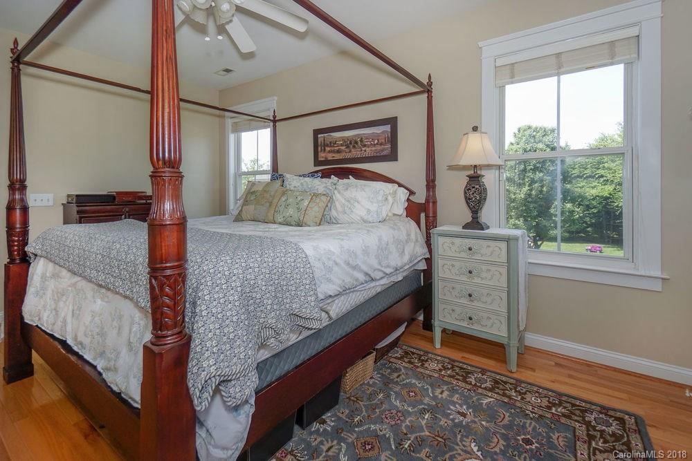 8117 Strandhill Road Huntersville, NC 28078 - Photo 17 of 36 a bedroom with a bed and a dresser next to a window