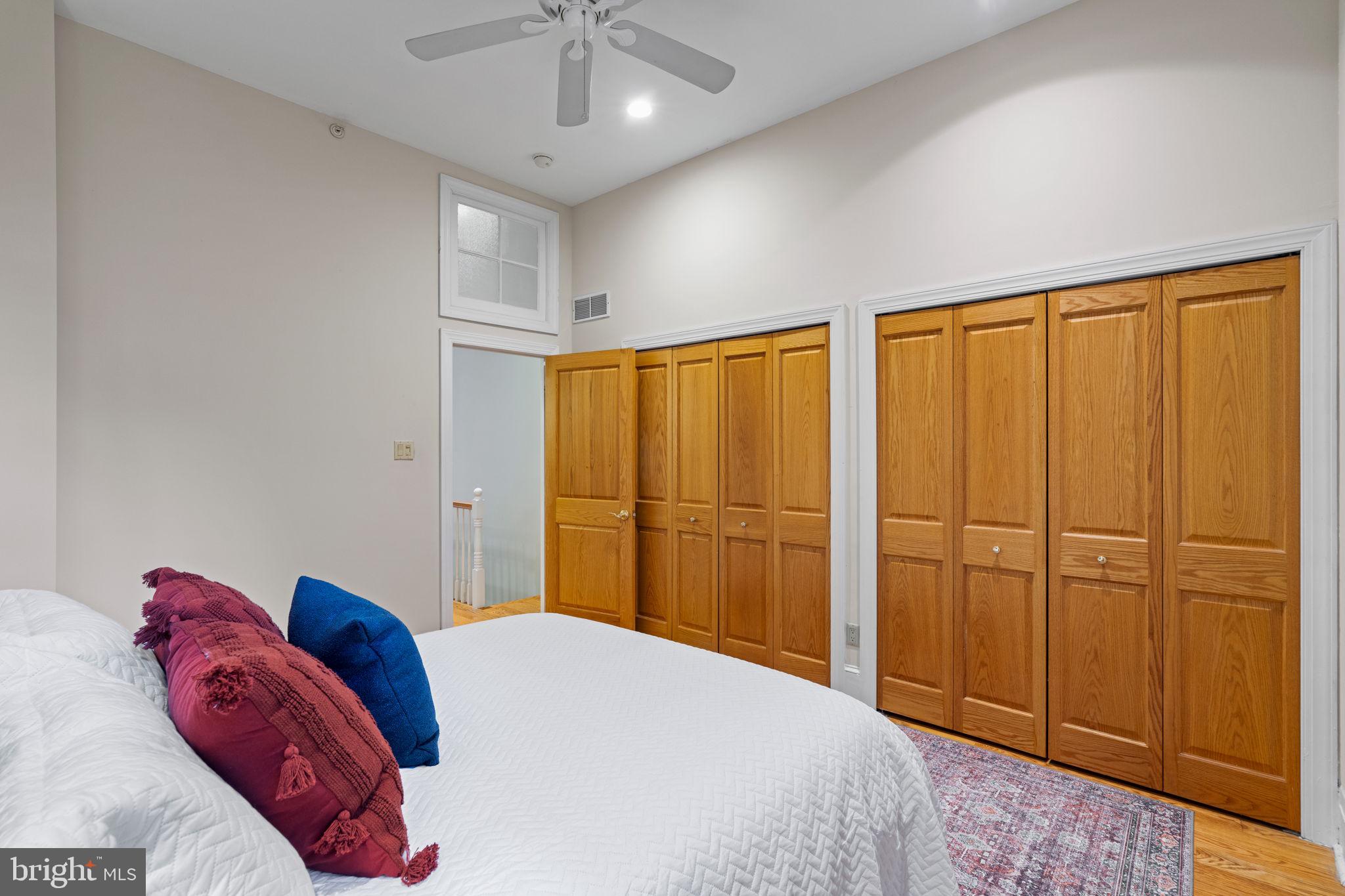 929 Clinton Street, Unit 1F Philadelphia, PA 19107 - Photo 22 of 41 a bedroom with a large bed and a chandelier