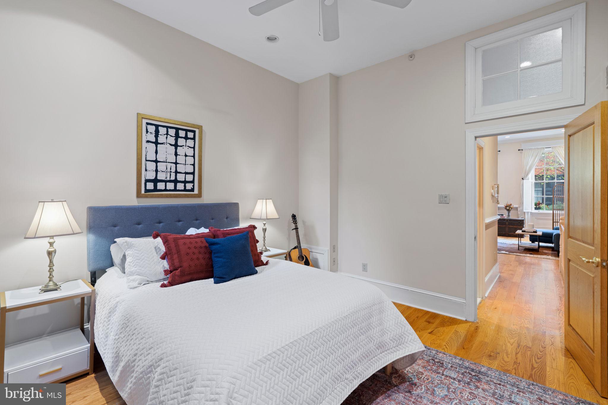 929 Clinton Street, Unit 1F Philadelphia, PA 19107 - Photo 23 of 41 a bedroom with a bed and wooden floor