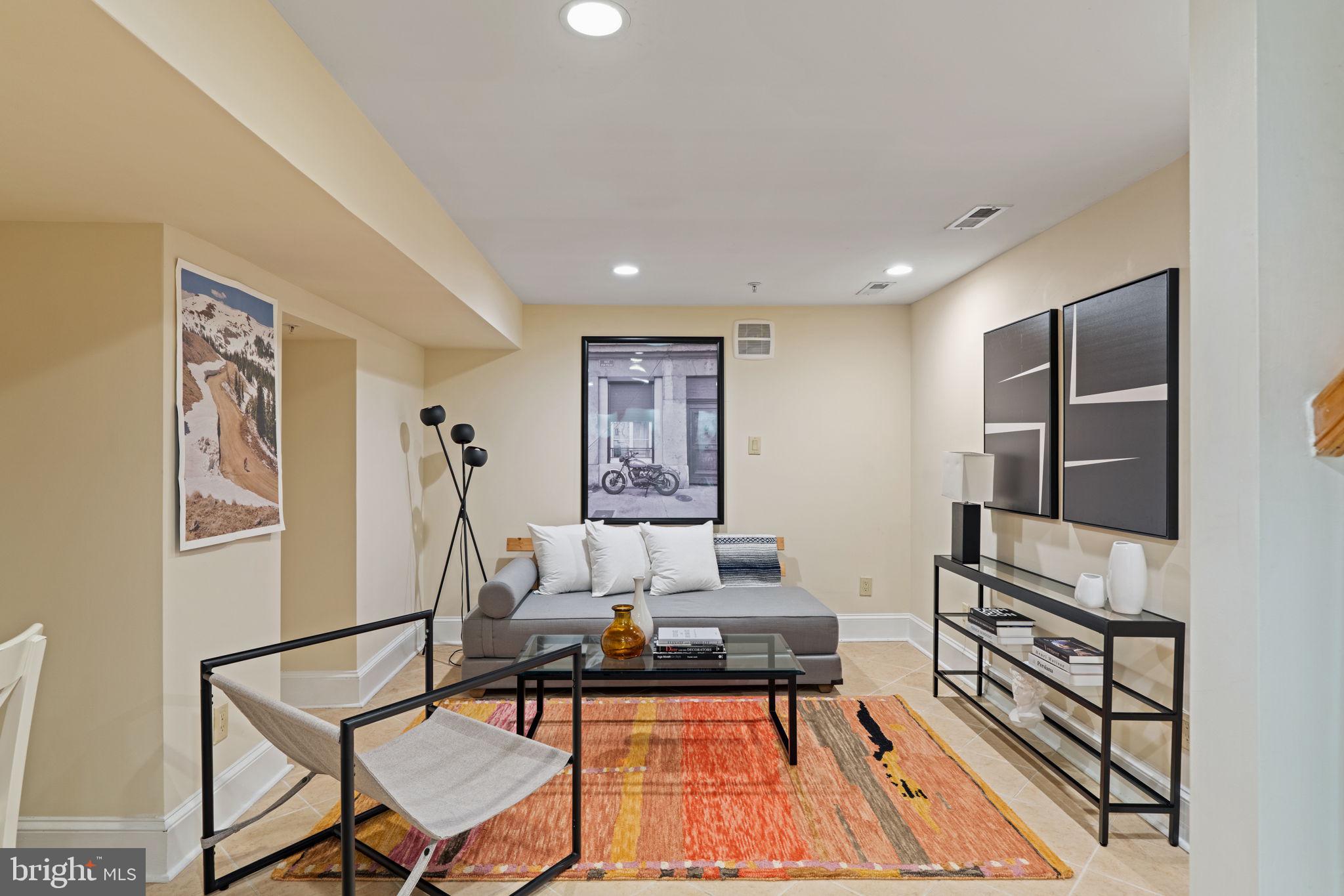 929 Clinton Street, Unit 1F Philadelphia, PA 19107 - Photo 28 of 41 a living room with furniture and a flat screen tv