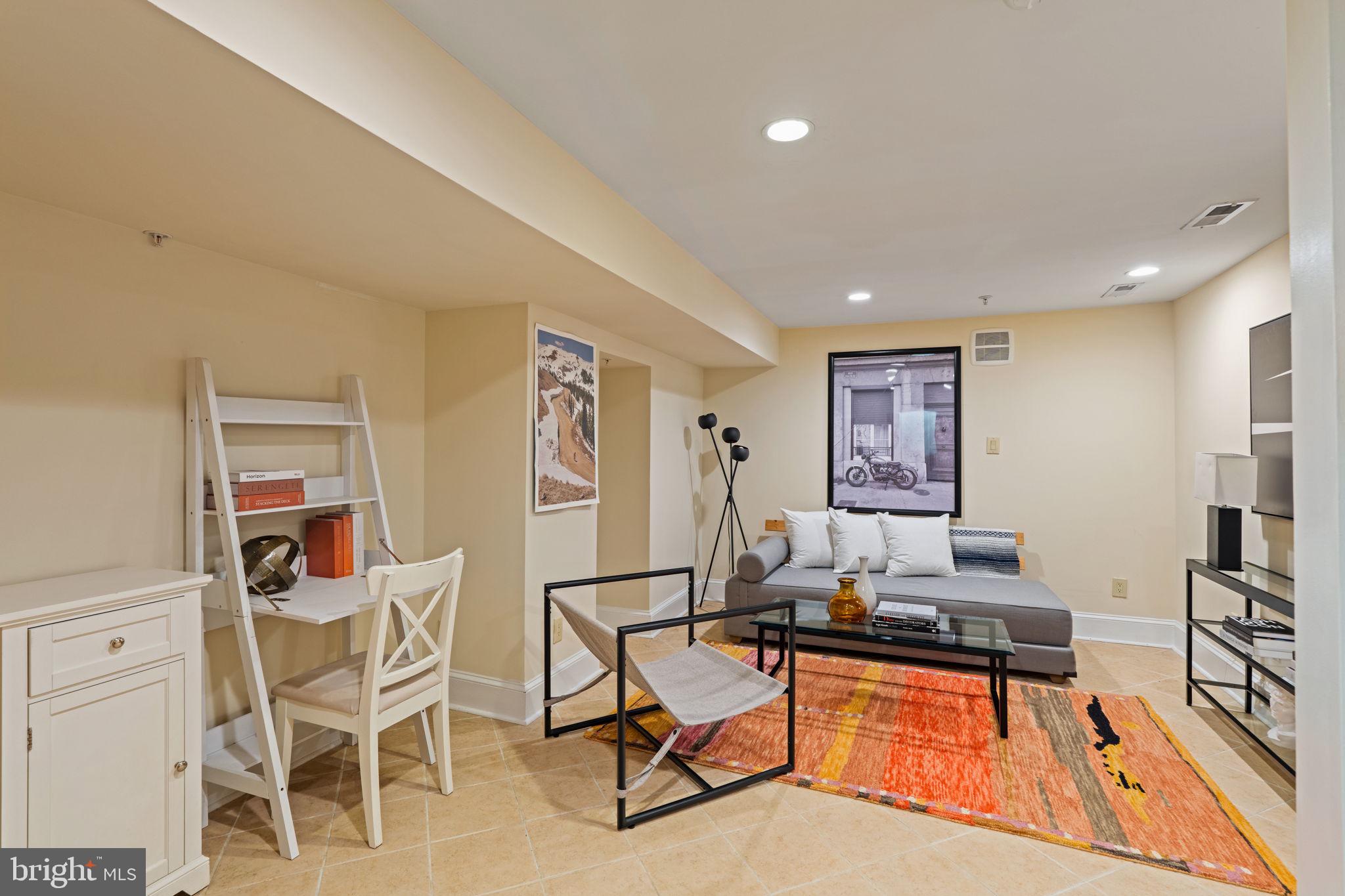 929 Clinton Street, Unit 1F Philadelphia, PA 19107 - Photo 29 of 41 a living room with furniture a flat screen tv and a table