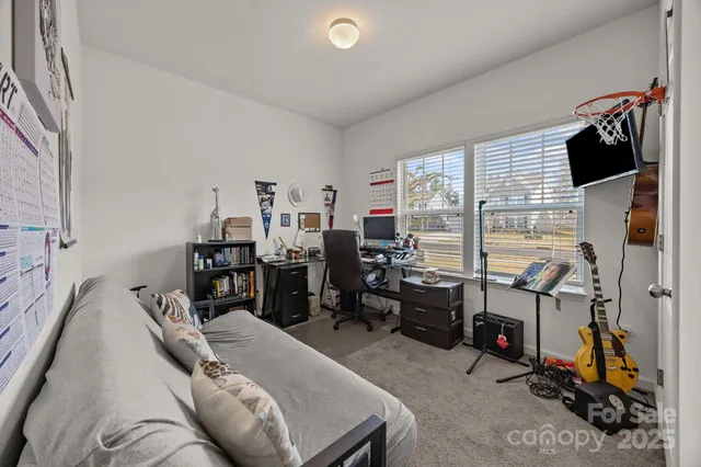 a bedroom with furniture and a flat screen tv