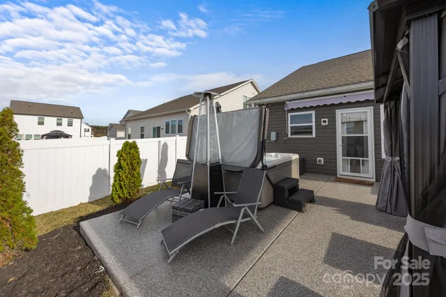 a backyard of a house with table and chairs