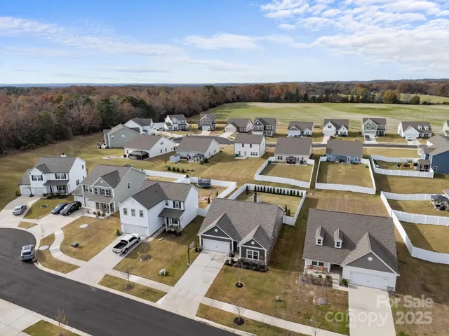 an aerial view of residential houses with city view