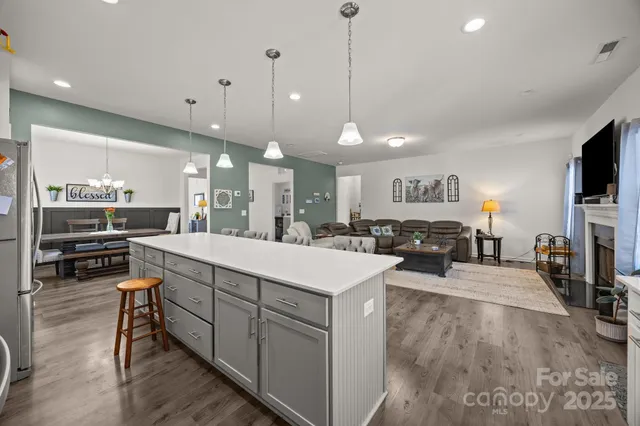 a large white kitchen with lots of counter space and a sink