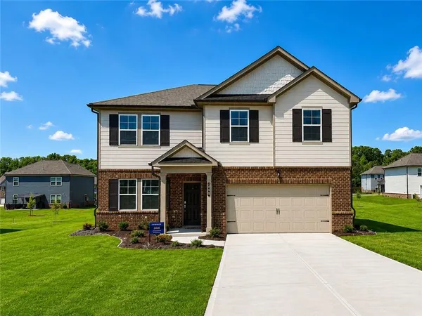 a front view of a house with a yard and garage