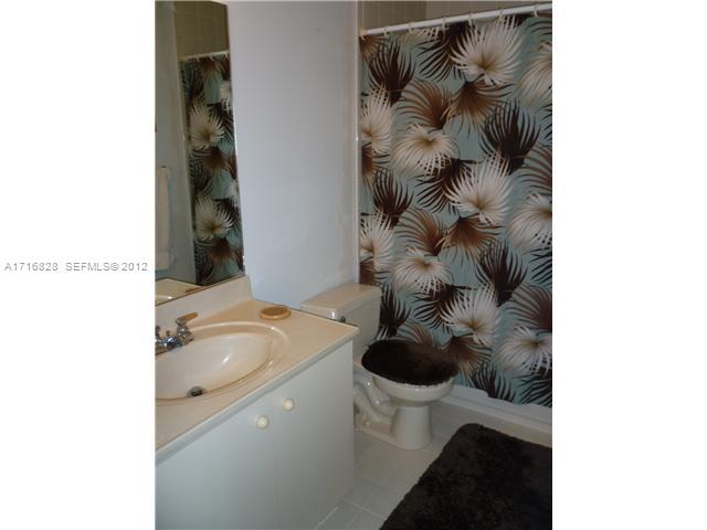 4070 Tree Top Road Cooper City, FL 33026 - Photo 11 of 12 a bathroom with a sink and a toilet