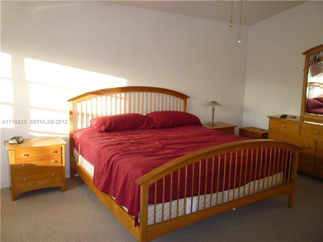 4070 Tree Top Road Cooper City, FL 33026 - Photo 7 of 12 a bedroom with a bed and a window