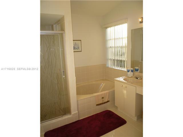 4070 Tree Top Road Cooper City, FL 33026 - Photo 8 of 12 a bathroom with a sink a toilet and shower