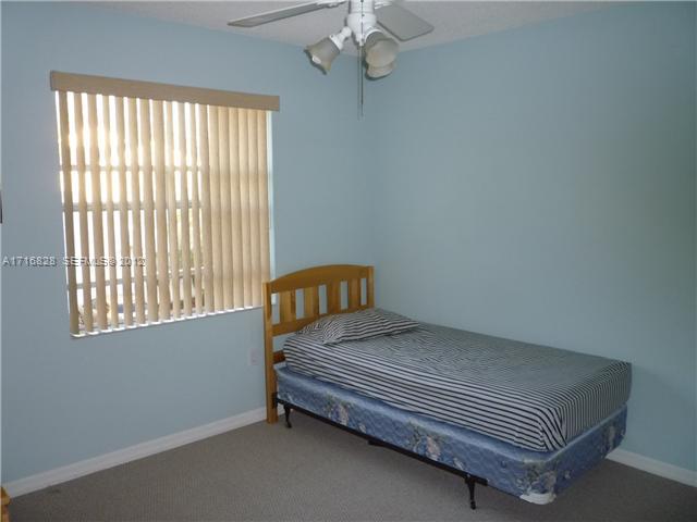 4070 Tree Top Road Cooper City, FL 33026 - Photo 9 of 12 a bedroom with a bed and window