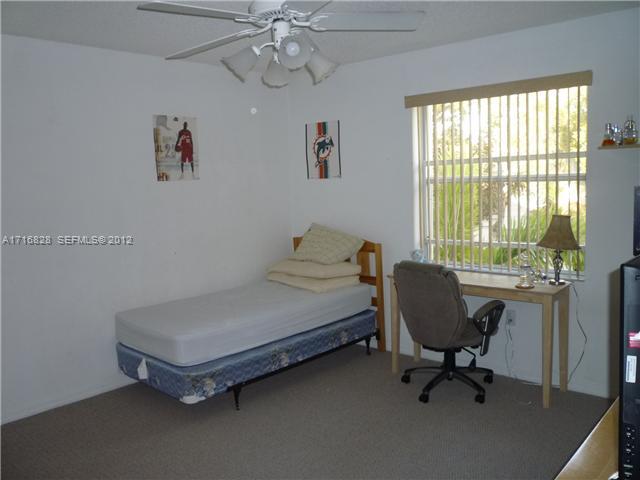 4070 Tree Top Road Cooper City, FL 33026 - Photo 10 of 12 a bedroom with a bed and a window