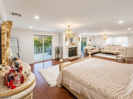 a spacious bedroom with a large bed and a fireplace