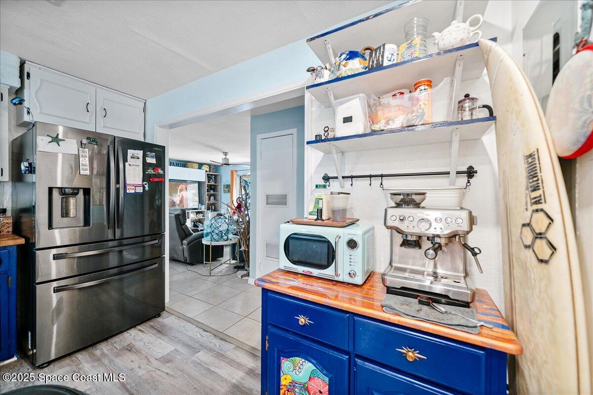 1405 Fiddler Avenue Merritt Island, FL 32952 - Photo 11 of 43 a kitchen with stainless steel appliances a stove a refrigerator and a table