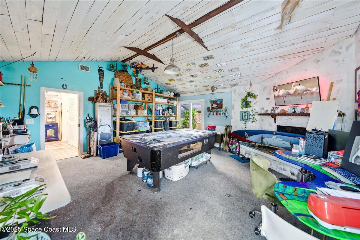 1405 Fiddler Avenue Merritt Island, FL 32952 - Photo 13 of 43 a room with furniture and a flat screen tv