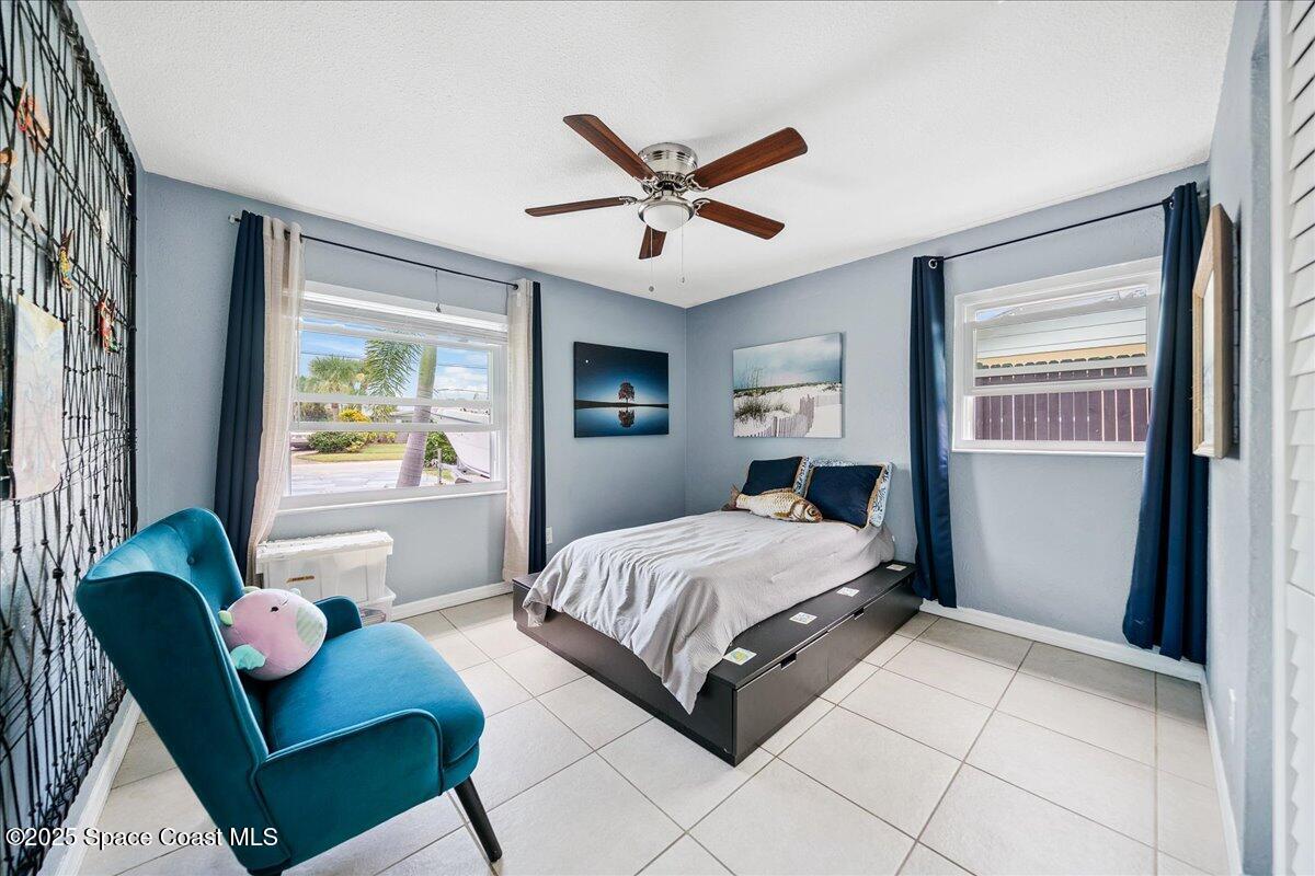 1405 Fiddler Avenue Merritt Island, FL 32952 - Photo 15 of 43 a bedroom with a bed couch and window