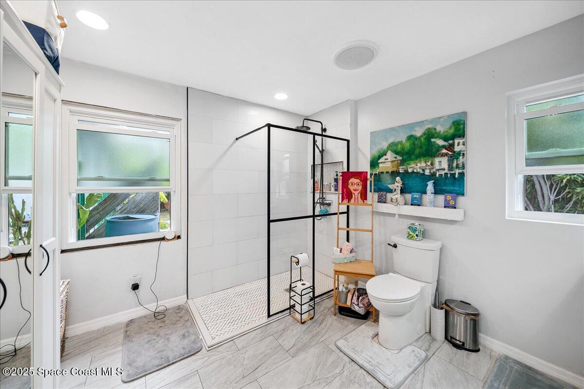 1405 Fiddler Avenue Merritt Island, FL 32952 - Photo 17 of 43 a bathroom with a toilet a sink and a shower