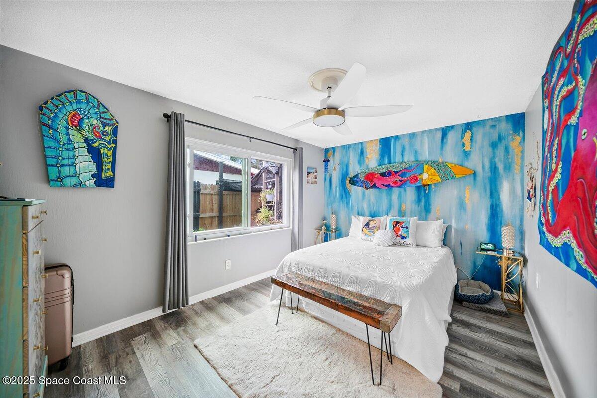 1405 Fiddler Avenue Merritt Island, FL 32952 - Photo 18 of 43 a bedroom with a bed a dresser and a book shelf