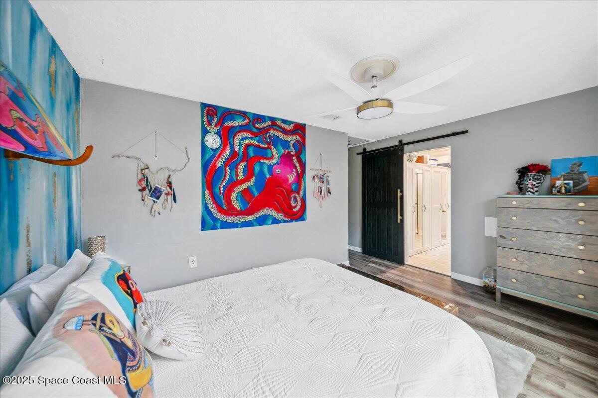 1405 Fiddler Avenue Merritt Island, FL 32952 - Photo 19 of 43 a bedroom with a bed and cabinets