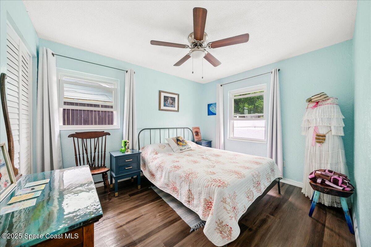 1405 Fiddler Avenue Merritt Island, FL 32952 - Photo 20 of 43 a bedroom with a bed and a chandelier