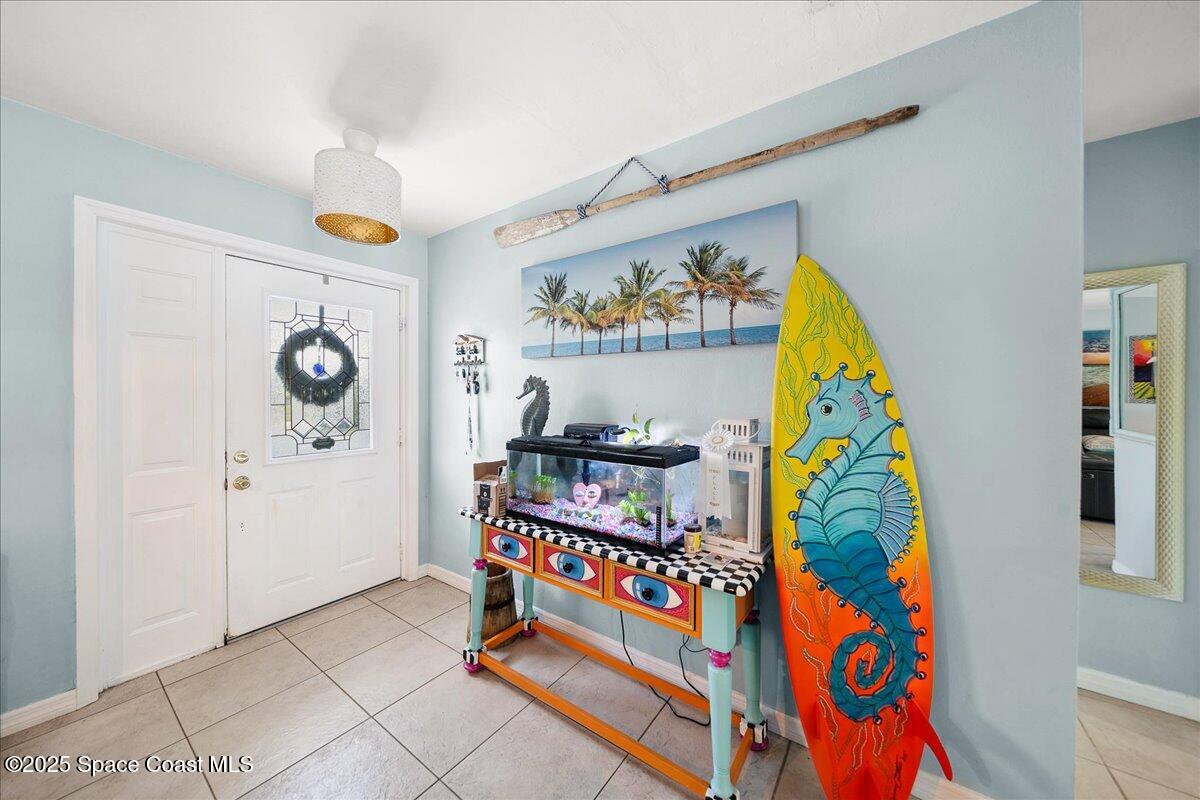 1405 Fiddler Avenue Merritt Island, FL 32952 - Photo 2 of 43 a view of an entryway with wooden floor and windows