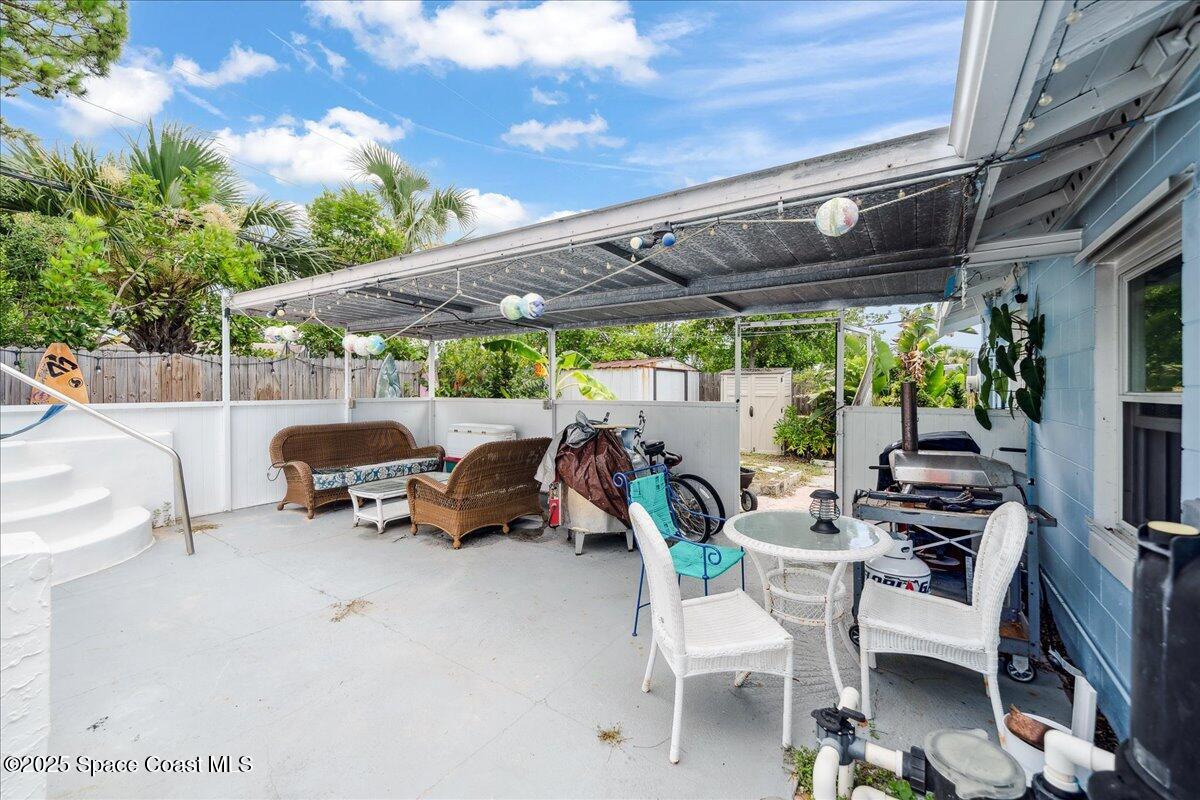 1405 Fiddler Avenue Merritt Island, FL 32952 - Photo 23 of 43 a view of patio with table and chairs and potted plants