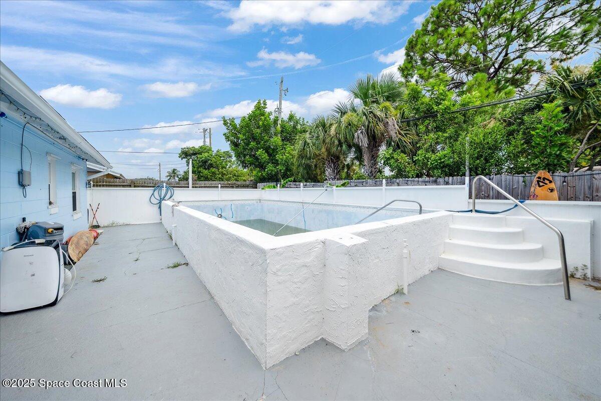 1405 Fiddler Avenue Merritt Island, FL 32952 - Photo 24 of 43 a view of a swimming pool with a patio