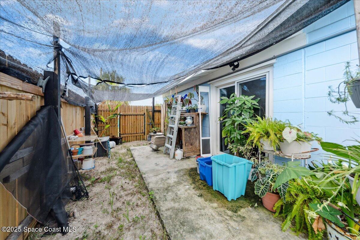 1405 Fiddler Avenue Merritt Island, FL 32952 - Photo 28 of 43 a view of a porch with potted plants
