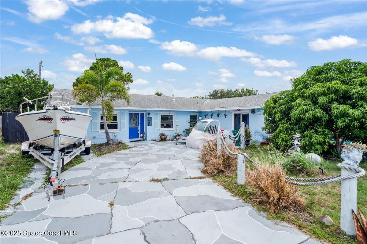 1405 Fiddler Avenue Merritt Island, FL 32952 - Photo 31 of 43 a front view of a house with garden