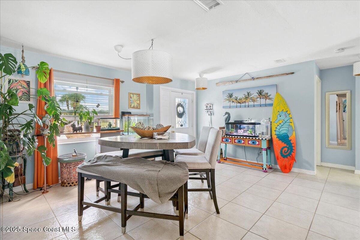 1405 Fiddler Avenue Merritt Island, FL 32952 - Photo 5 of 43 a dining room with furniture and a table