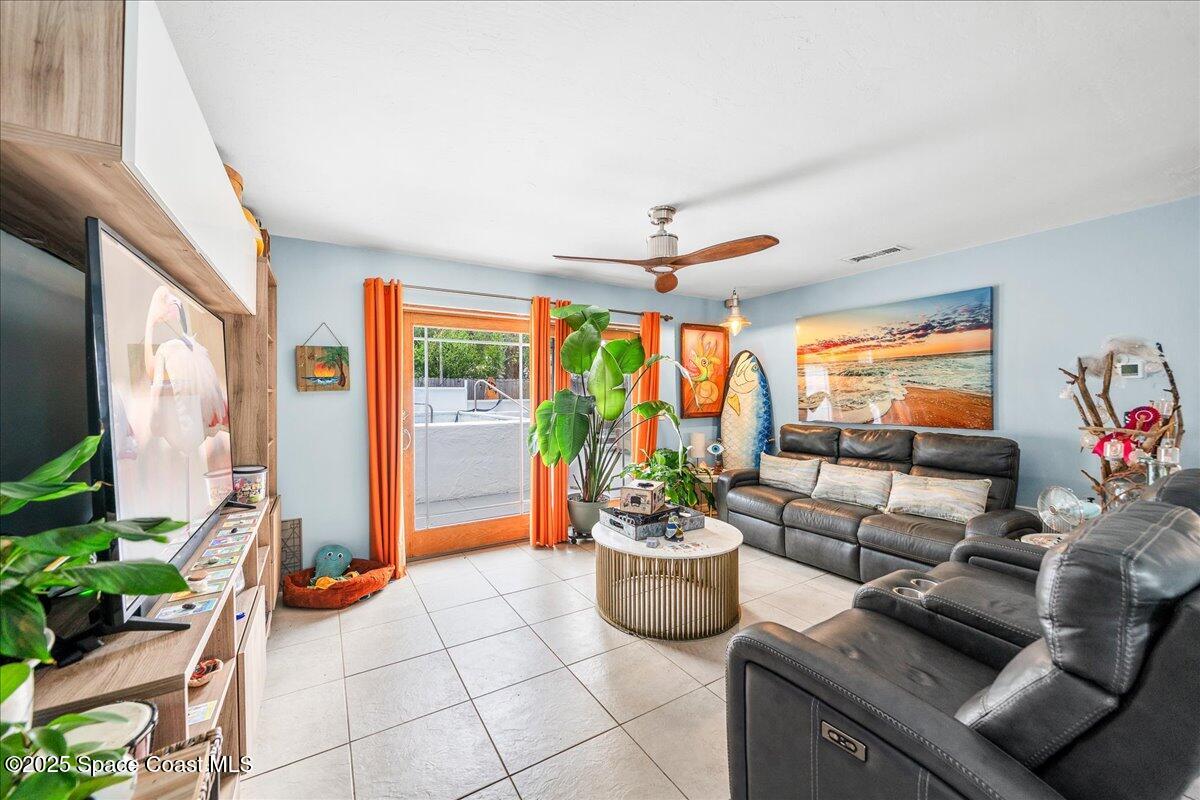 1405 Fiddler Avenue Merritt Island, FL 32952 - Photo 6 of 43 a living room with furniture and a potted plant